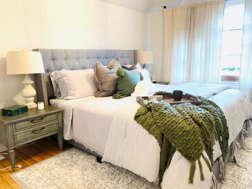 a bedroom with a bed with white sheets and pillows at Vida Boutique Inn in Worcester
