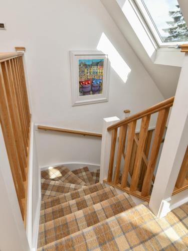 a staircase in a house with a skylight at Tarskavaig B&B in Radernie