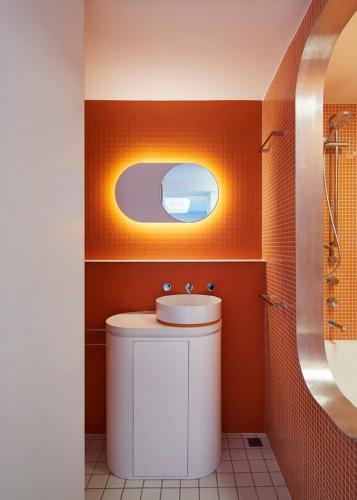 a bathroom with a sink and a mirror at Hub 14 in Falls Creek