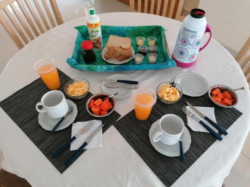 a table with a breakfast of food and orange juice at El Prado in Santa Cruz de la Sierra