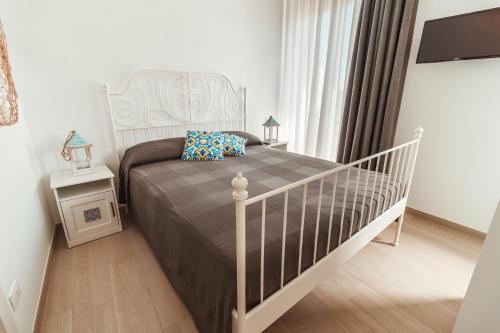 a bedroom with a bed and a crib in a room at FeMa B&B - Housea in Polignano a Mare