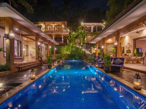 a large swimming pool in the middle of a house at Puri Kasih Gottlieb in Ubud