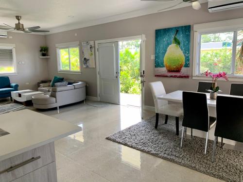 a kitchen and living room with a table and chairs at The Marina Villa de Sonja in Ocho Rios