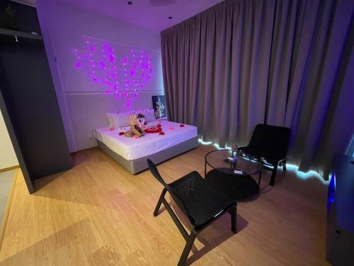 a bedroom with a bed and two dolls on it at Kuantan Imperium by Glex in Kuantan