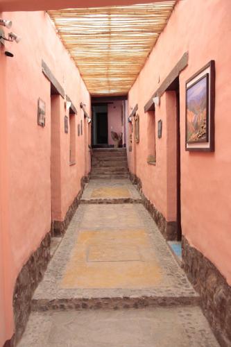 an empty hallway in an old building with a long corridor at Hosteria La Estacion in Tilcara