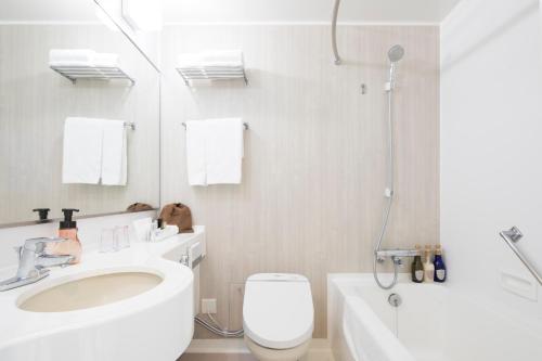 a bathroom with a toilet and a sink and a shower at HOTEL MYSTAYS PREMIER Narita in Narita