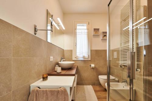 a bathroom with a sink and a toilet at ApartmentsGarda - Garda31 Residence in Garda