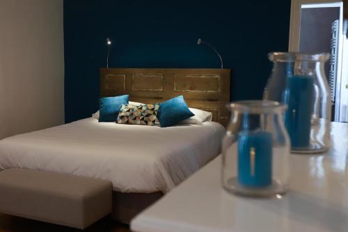 a bedroom with a bed and a table with a vase at DEMEURE DES CORDELIERS avec parking privé in Blois