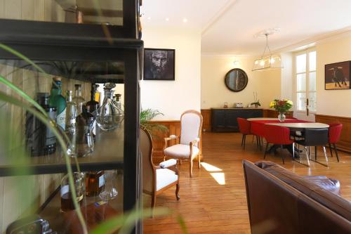 a living room with a table and a dining room at DEMEURE DES CORDELIERS avec parking privé in Blois