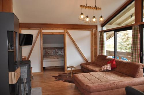 a living room with a couch and a tv at Appartement Wenger in Bad Hofgastein