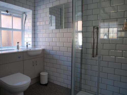 a bathroom with a toilet and a glass shower at Red Lion in Exeter