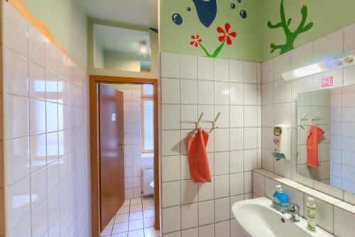 a bathroom with a sink and a toilet at Hostel Lollis Homestay Dresden in Dresden