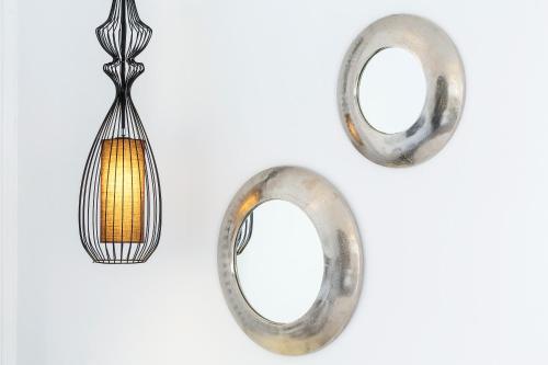 a pair of metal hoop earrings with a light fixture at Aroma Suites in Fira