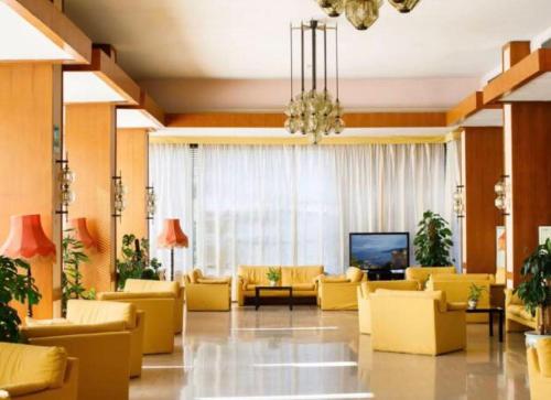 a living room filled with furniture and a large window at Grand Hotel Cesare Augusto in Sorrento