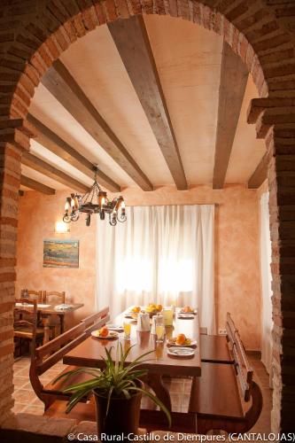 a dining room with a table with food on it at Casa Rural Castillo Diempures in Cantalojas