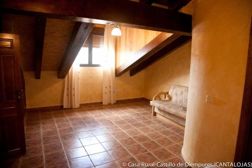 a living room with a couch and a window at Casa Rural Castillo Diempures in Cantalojas