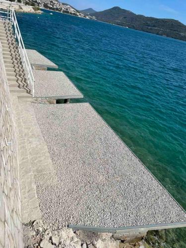 a group of steps leading into the water at Apartments Lukrecia in Neum