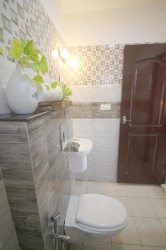 a bathroom with a toilet and a sink at North Centre in Cochin