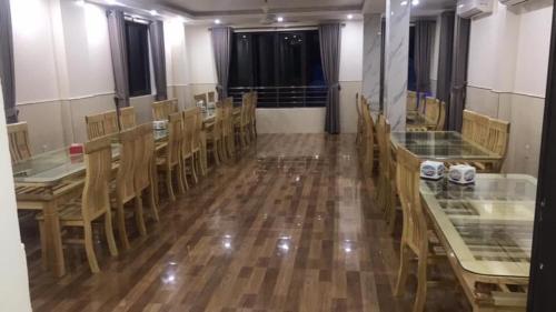 a dining room with wooden tables and chairs at TIẾN LUẬT in Cat Ba