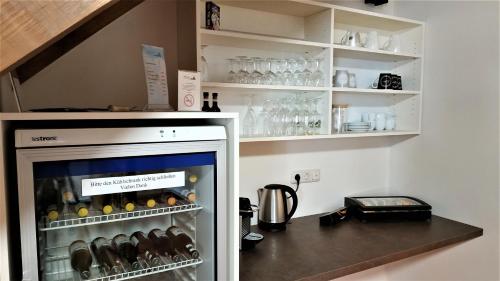 a refrigerator filled with lots of bottles and glasses at Altstadthotel Goldene Kugel in Waren