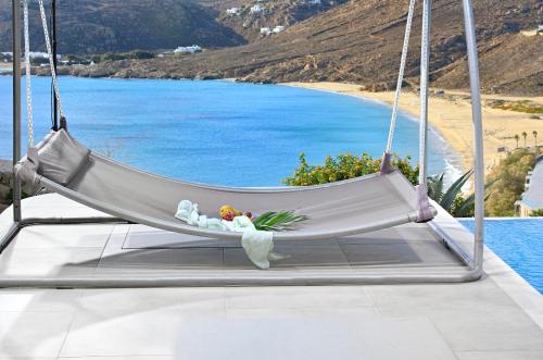 a hammock with a view of a beach at Luxurious Villa Ostria in Elia Beach