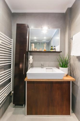 a bathroom with a white sink and a mirror at Ladadika Design, Philian Hotels and Resorts in Thessaloniki
