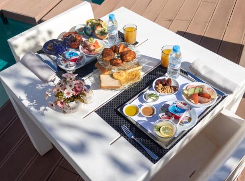 a table with breakfast foods and drinks on it at Hôtel Souani ( Al Hoceima Bay) in Al Hoceïma