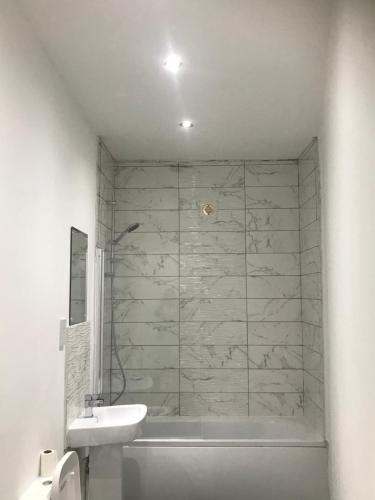 a bathroom with a tub and a sink and a shower at Norton Road in Stockton-on-Tees
