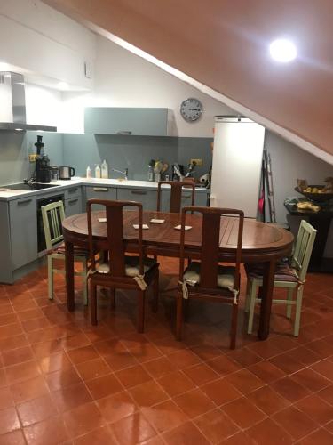 a kitchen with a wooden table and chairs in a kitchen at Villa sainte claire in Amélie-les-Bains-Palalda