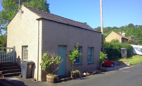 a small house on the side of a street at Cottage - Sleeps 4 - Pets Ok - Garden - Parking in Carnforth