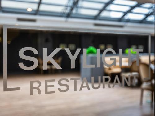a sign that reads skylight restaurant in a building at Sky Hotel Baku in Baku