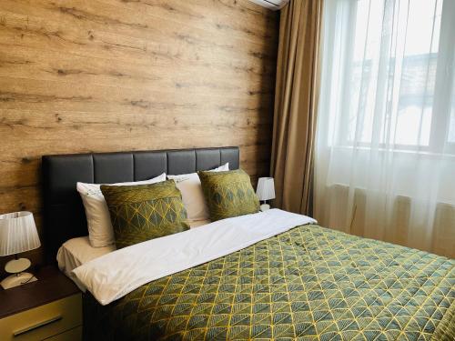 a bedroom with a bed with a wooden wall at Gabala Sweet Lounge in Gabala