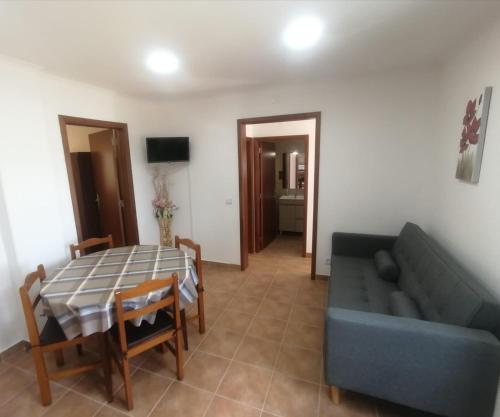 a living room with a couch and a table at Monte da Vinha Nova in Santiago do Cacém