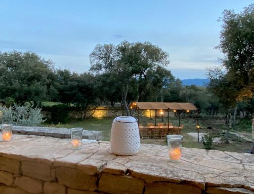 a stone table with candles on a stone wall at Lou Mas in Gordes