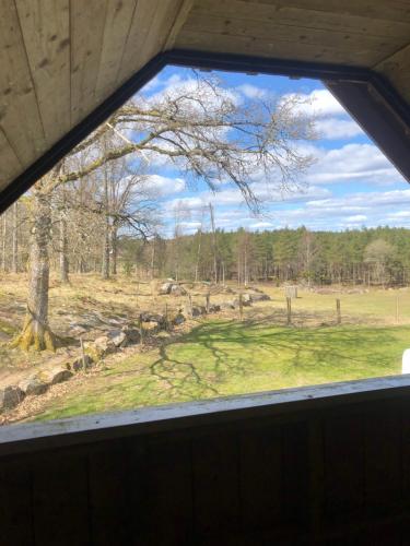 a window in a building with a view of a field at Sävekulla 207 "Brygghuset" in Älvsered