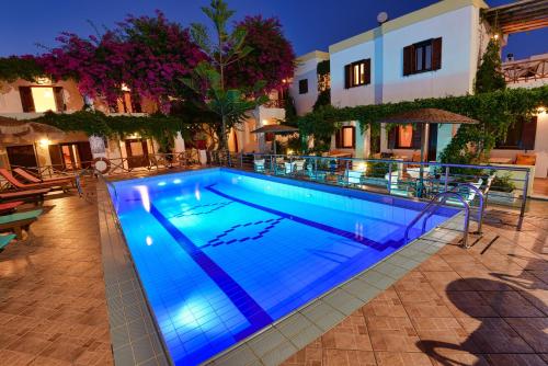 a swimming pool with blue lighting in a hotel at Galissas Studios in Galissas