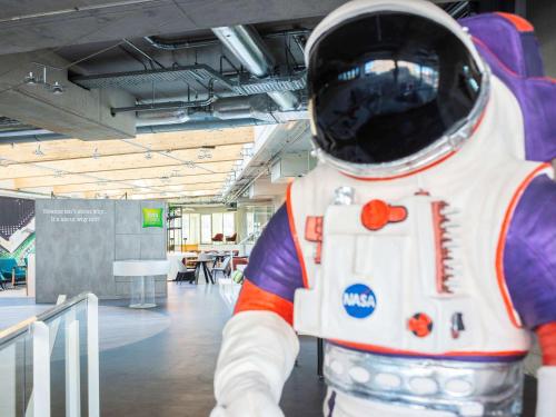 a mannequin of an astronaut suit in a room at ibis Styles Delft City Centre in Delft