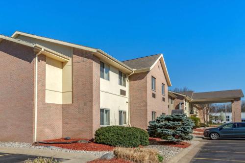 a house with a car parked in front of it at Comfort Inn & Suites in Paw Paw