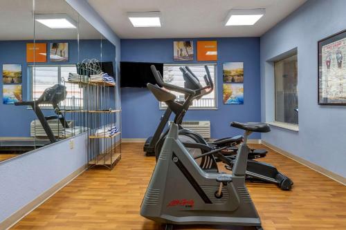 a gym with several tread machines in a room at Comfort Inn & Suites in Paw Paw