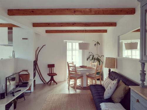 a living room with a couch and a table at Casa da Bica d'Água in Óbidos