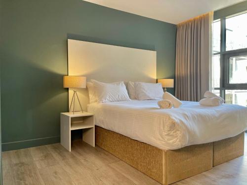 a bedroom with a large bed and a window at Axiom Park Hotel in London