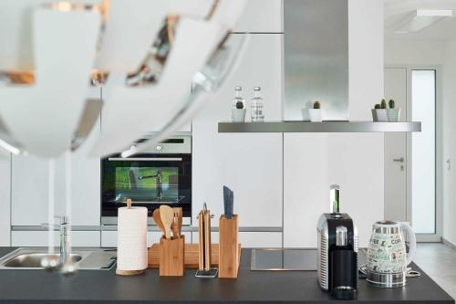 a kitchen with a counter top with wooden utensils at Meeresvilla Lobbe in Lobbe