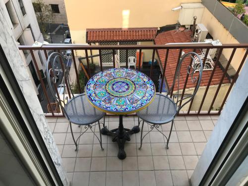 a table and four chairs on a balcony at International Naples in Naples