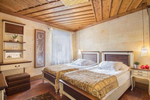 Cama o camas de una habitación en Cappadocia Minia Cave Hotel