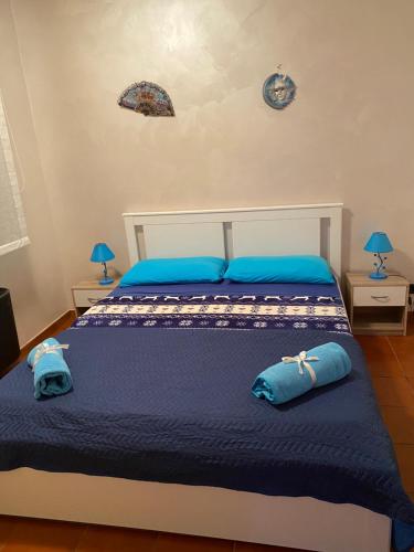 een slaapkamer met een bed met blauwe kussens erop bij Azul - privacy tranquillità natura e mare in Rosolina Mare