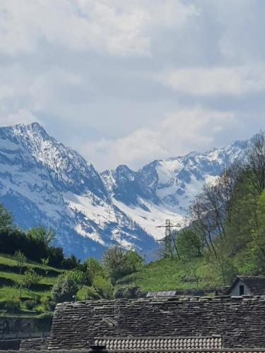 a mountain range with snow covered mountains in the background at Coccinella House in Calasca Castiglione