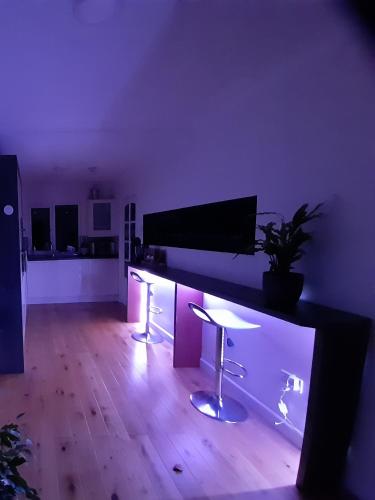 a living room with a desk with a keyboard at Sunny-side-up in St Austell