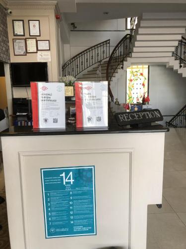 a counter in a store with a staircase in the background at New Balturk Hotel Izmit in Kocaeli