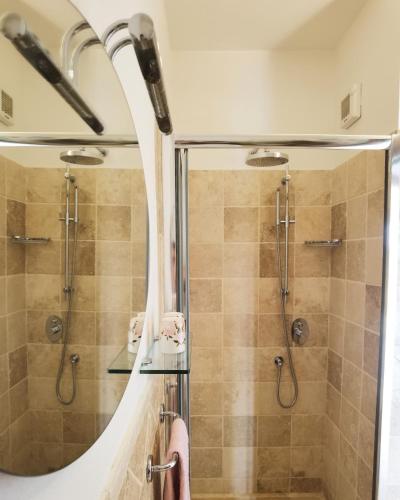 a bathroom with a shower and a mirror at Casa Panorama in Casole dʼElsa