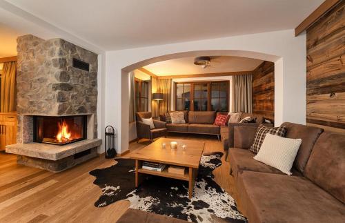 a living room with a couch and a fireplace at Haus Gertrud in Sankt Anton am Arlberg